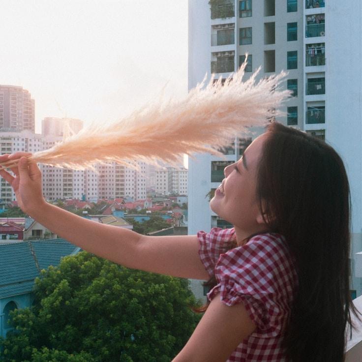 Kaveri Mehta, Lead Design Curator at Open Sky Network Group, reviewing corporate floral arrangements